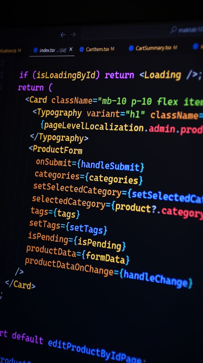 Close-up of JSX code on a monitor, showcasing colorful syntax used in ReactJS development.